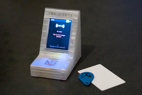 An Attractap reader beside an NFC key fob and an NFC card