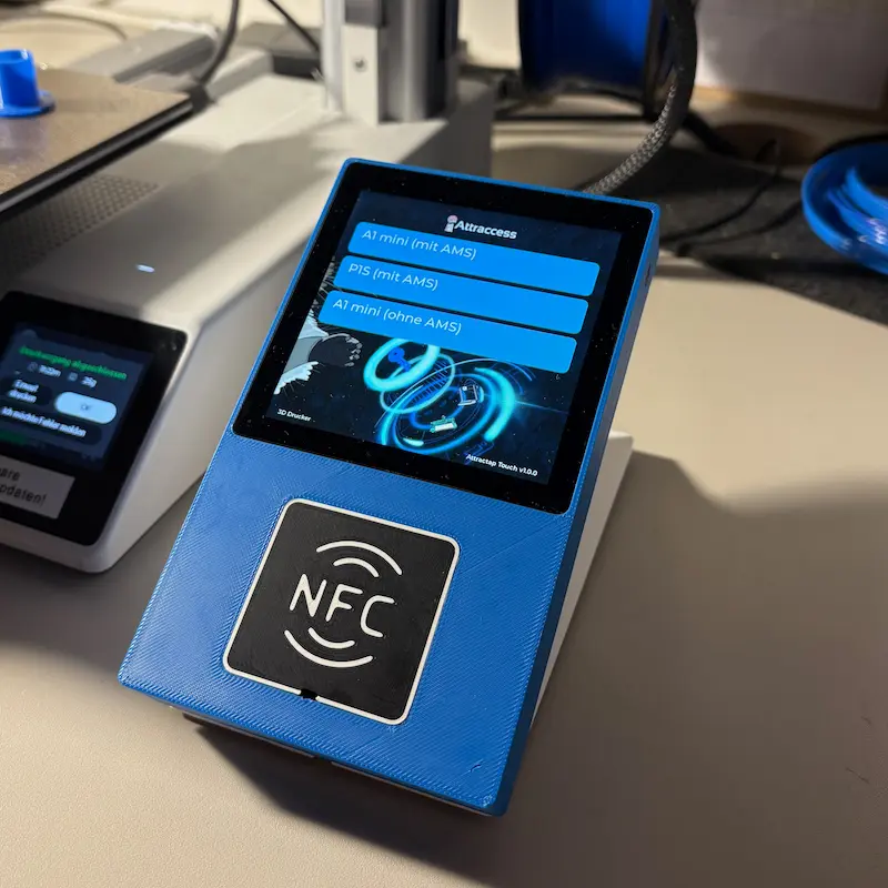 An Attractap Touch reader mounted next to a 3D printer, showing a resource list